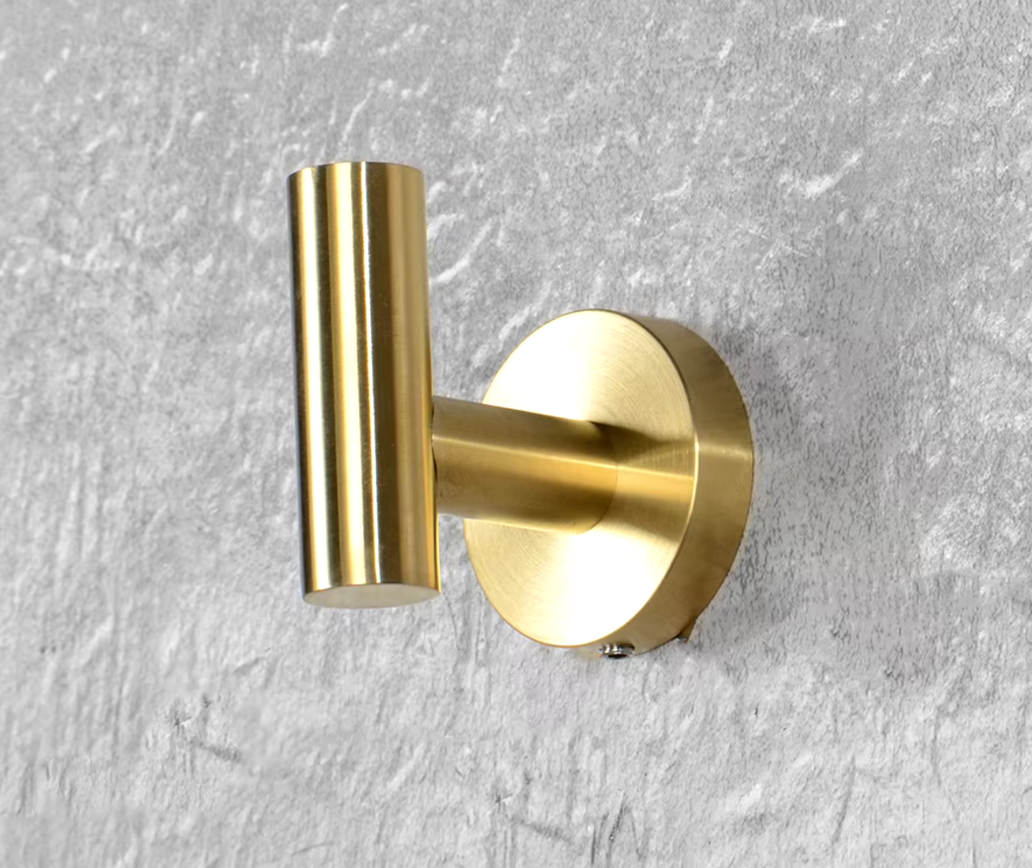 Brushed Brass gold robe hook fixed to a wall